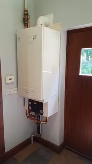 A tank mounted to the side of a wall.